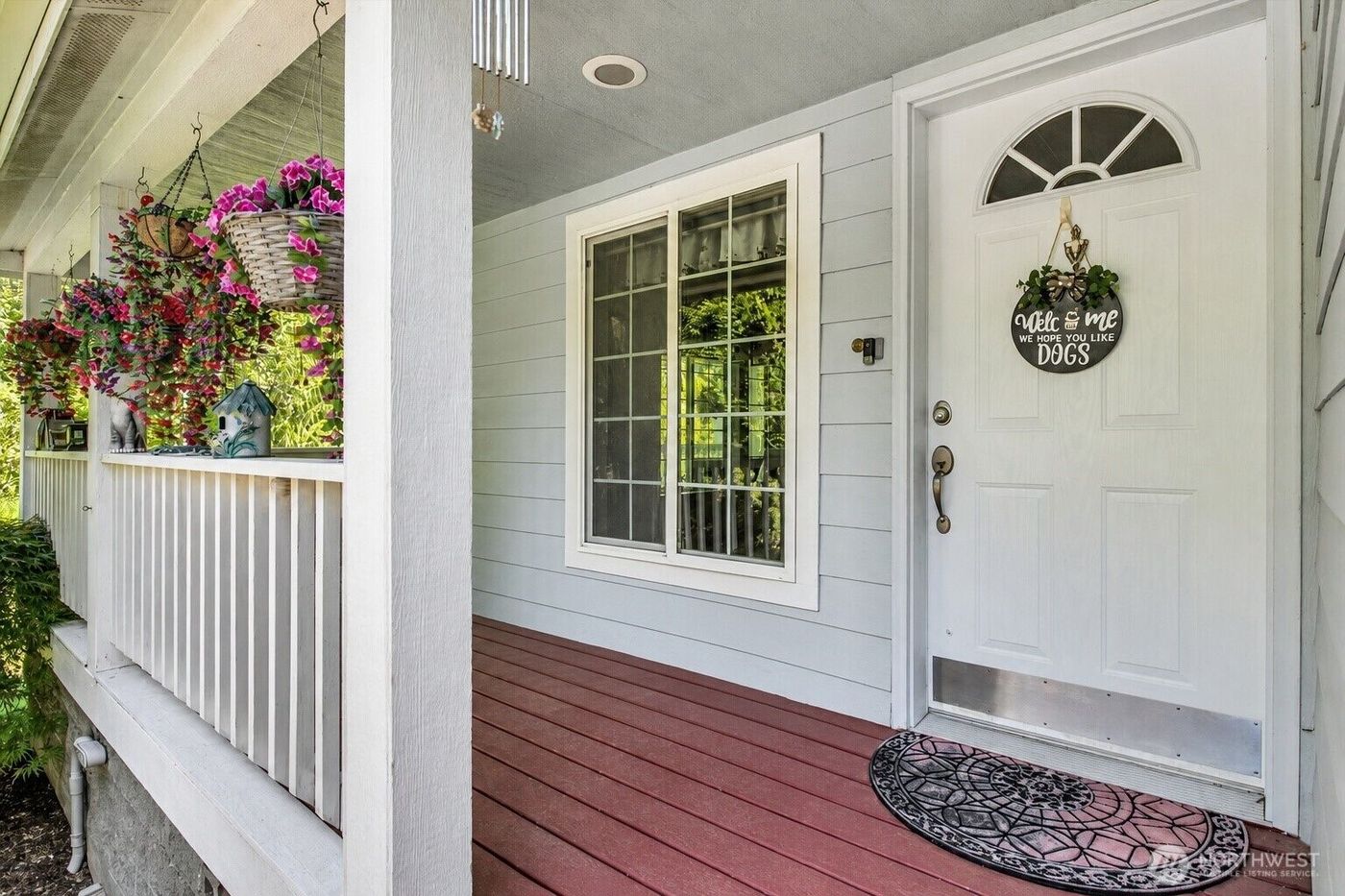 Covered front porch with hanging flowers