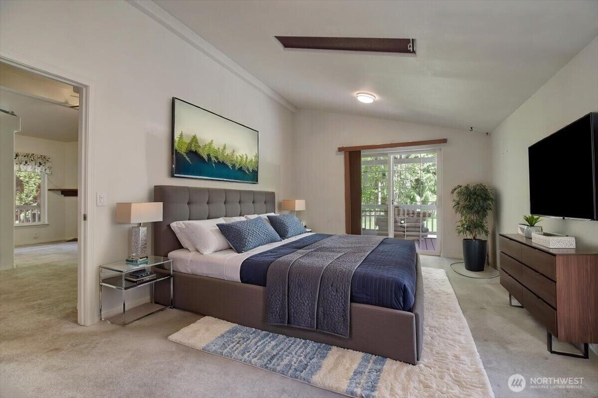 Primary bedroom with doors to the covered porch