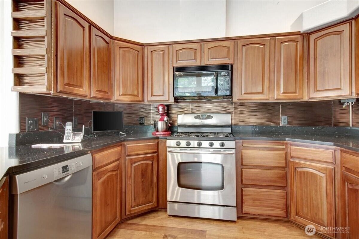 Kitchen with gas range and oak cabinetry