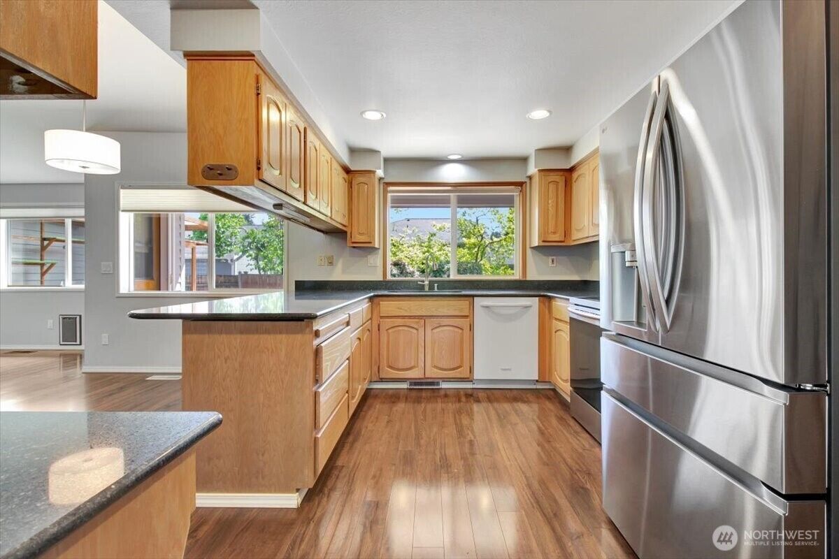 Kitchen with stainless appliances and granite counters
