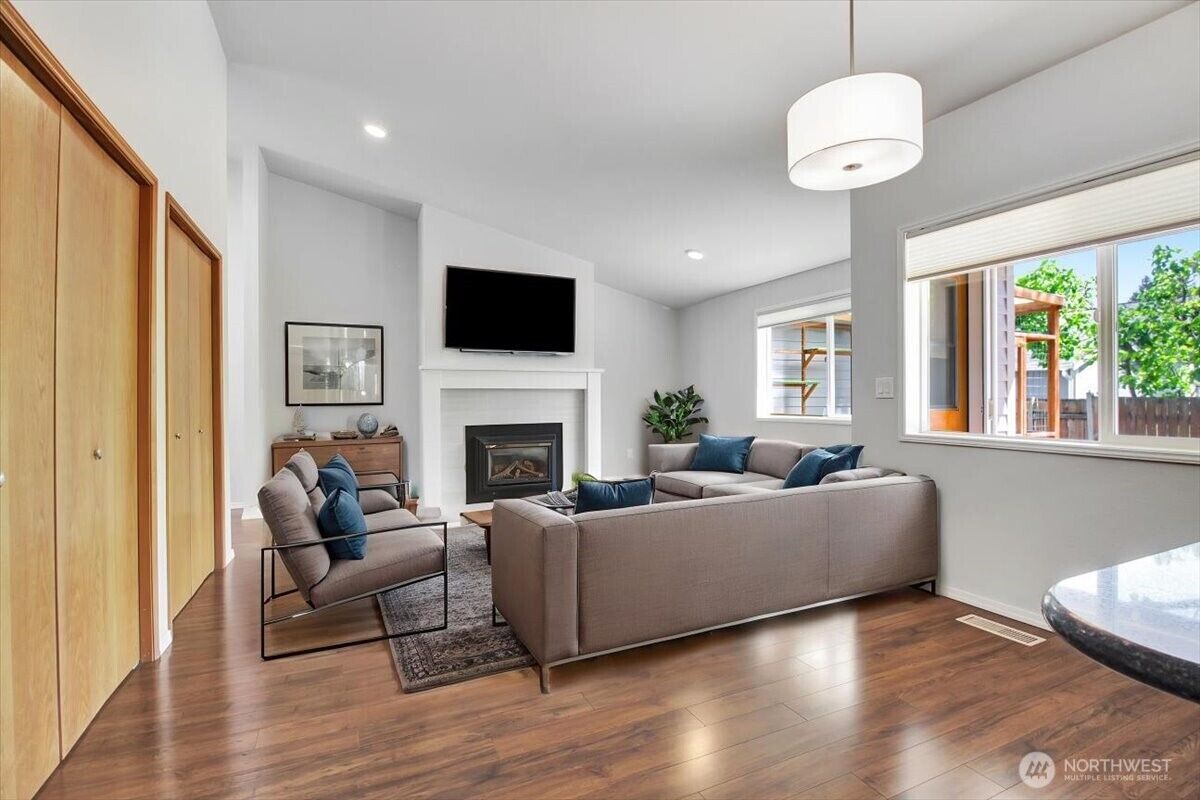 Living room with gas fireplace and vaulted ceiling