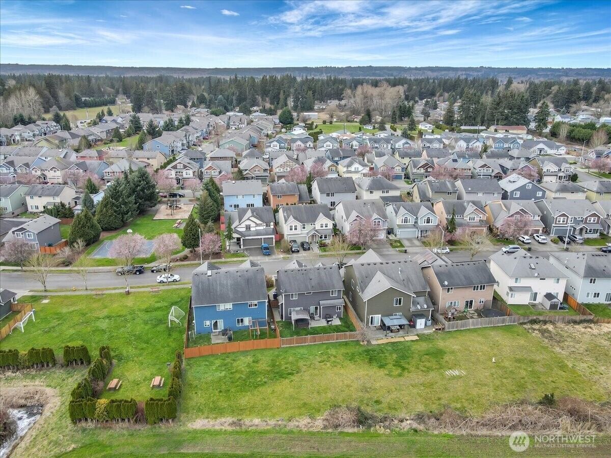 Aerial view over the neighborhood toward open fields