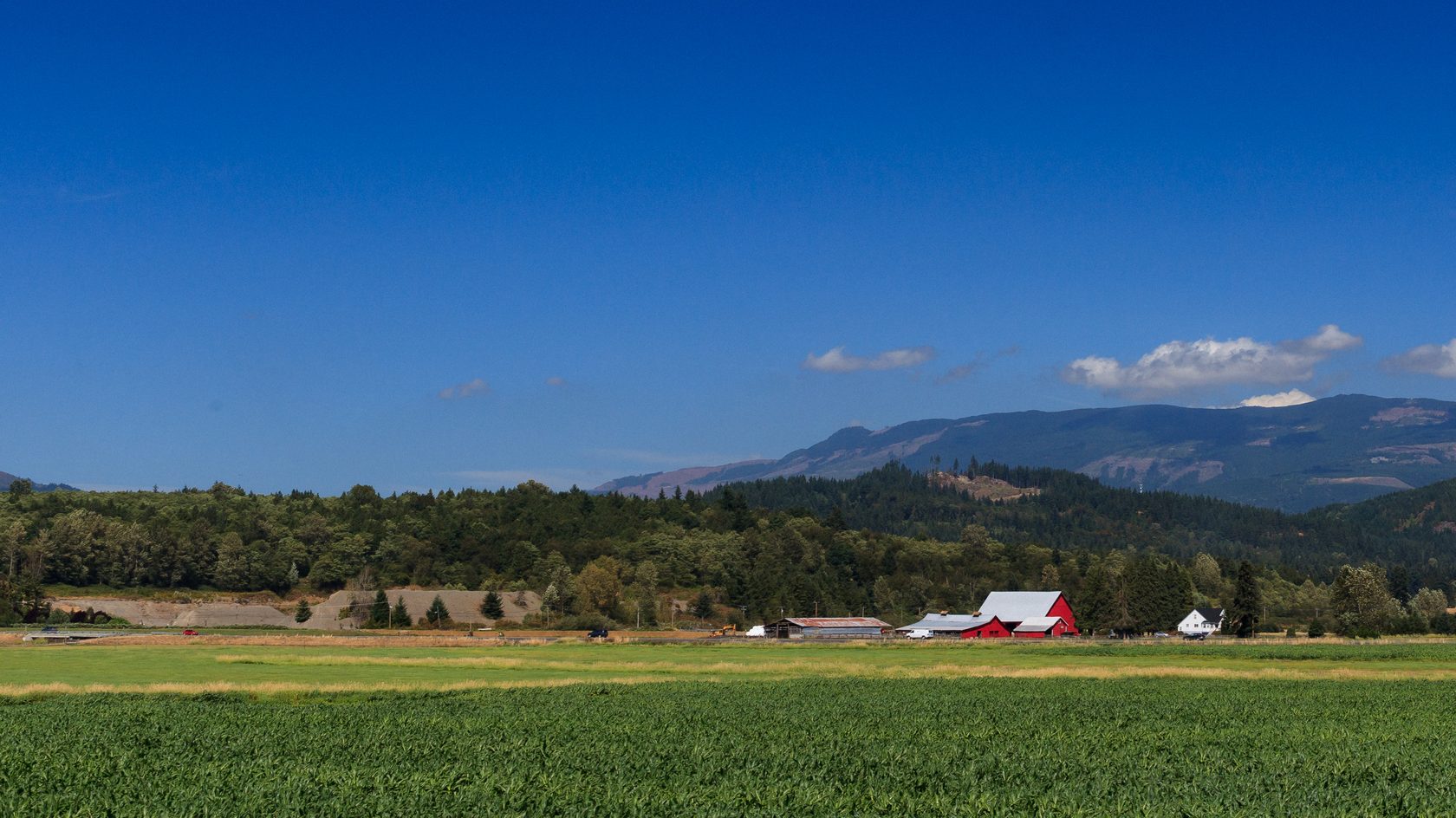 A red barn and farm fields below Lyman Hill near Burlington