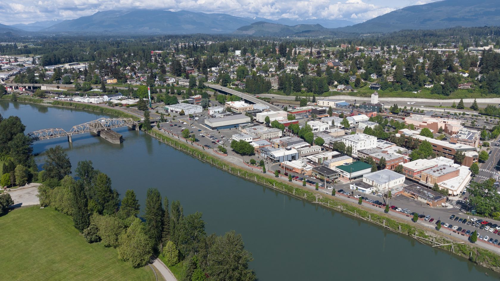 Aerial view of downtown Mount Vernon and the Skagit River, with the foothills behind
